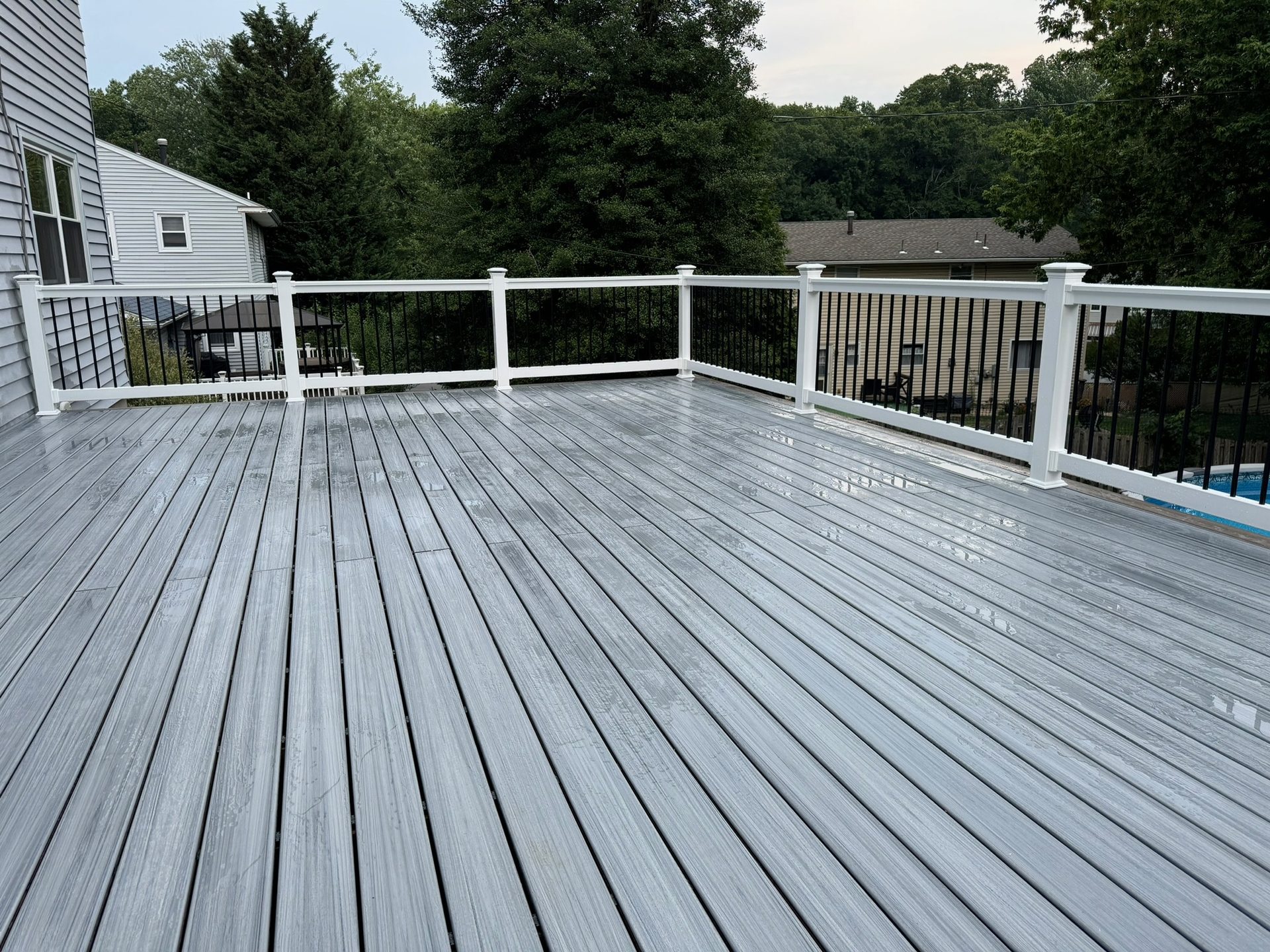 Elevated composite deck overlooking the backyard pool