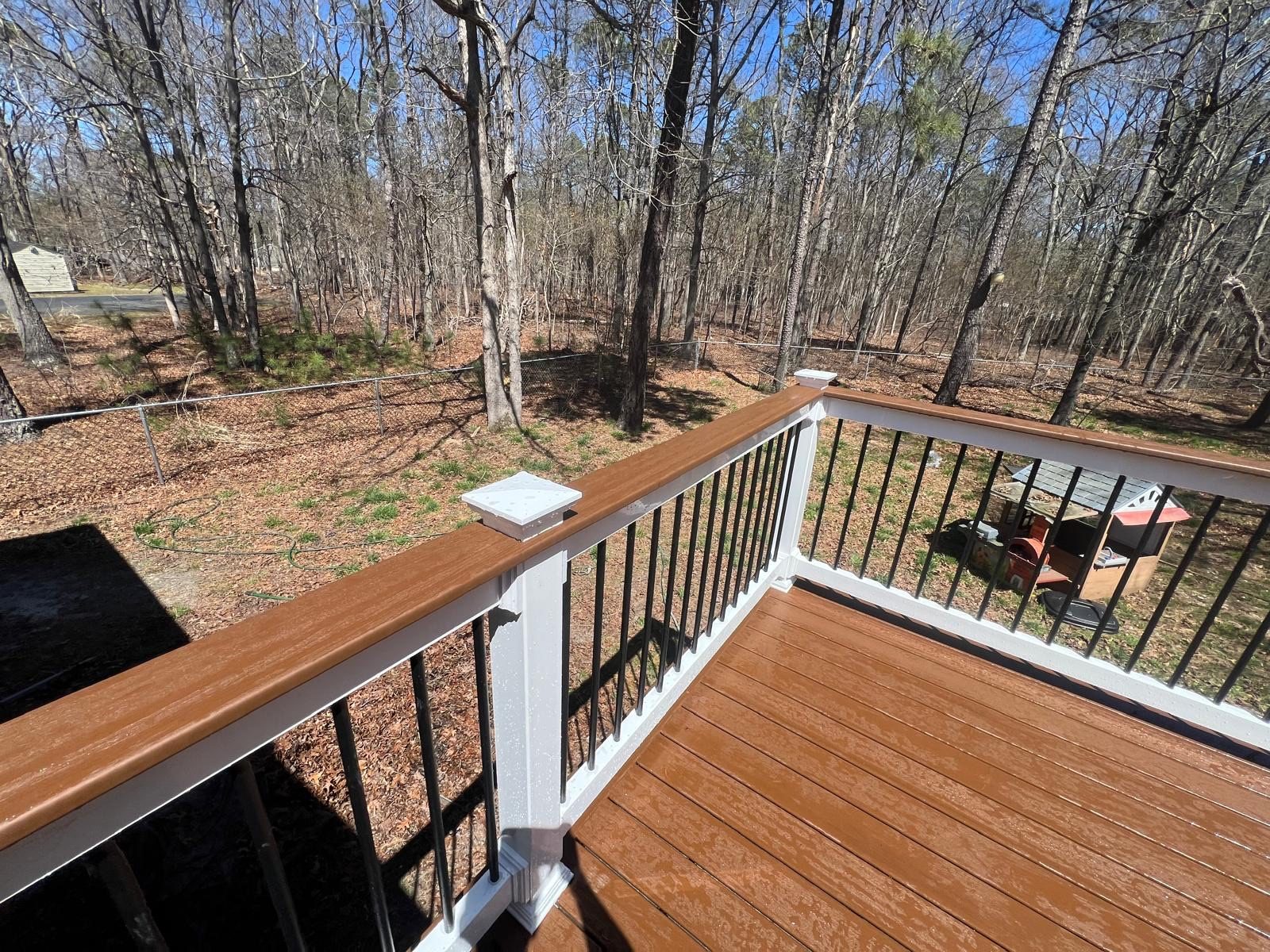 Composite deck and railing detail in a warm stain tone