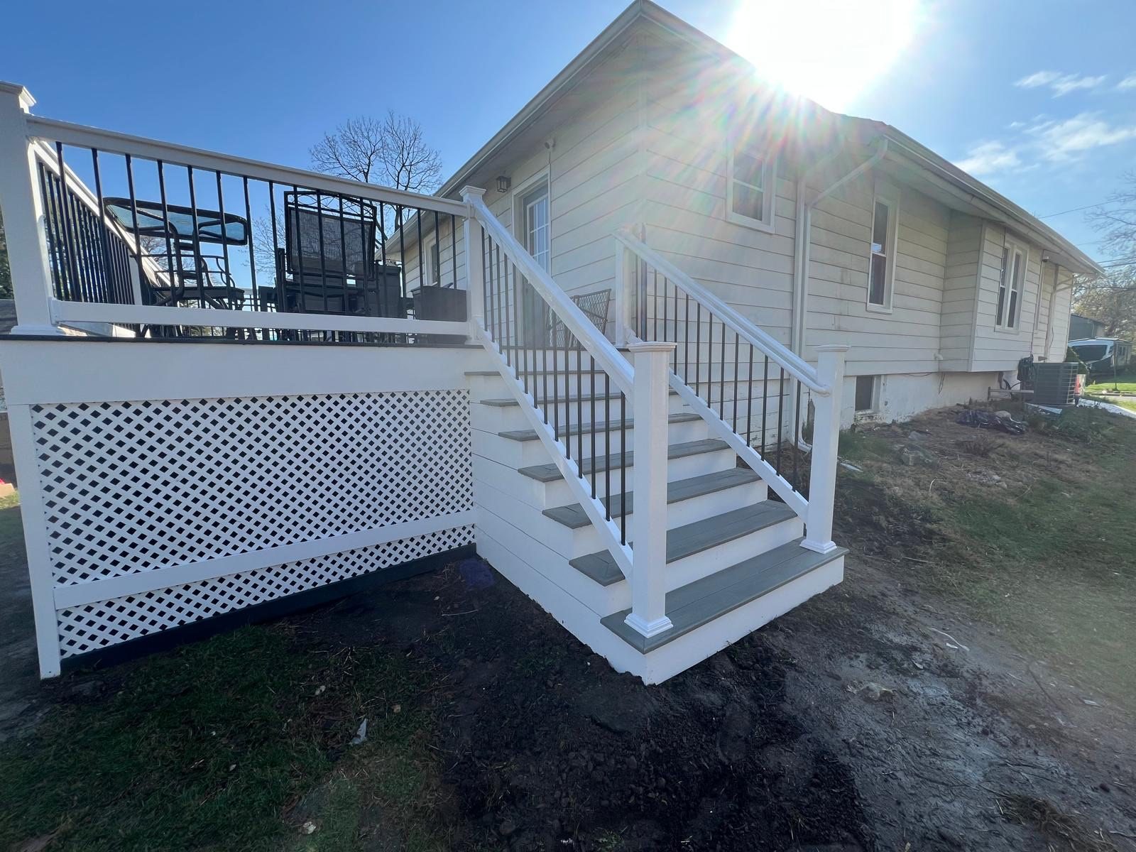 Front porch stairs with black aluminum railings
