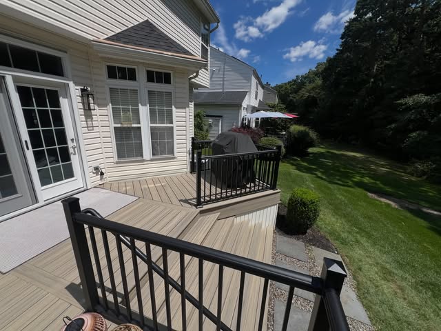 Front porch with white railings and staircase